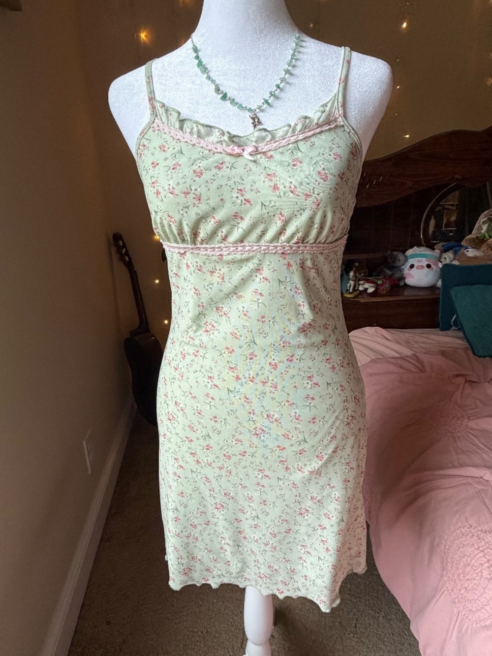 This adorable sage green mini slip dress features an all-over ditsy floral print